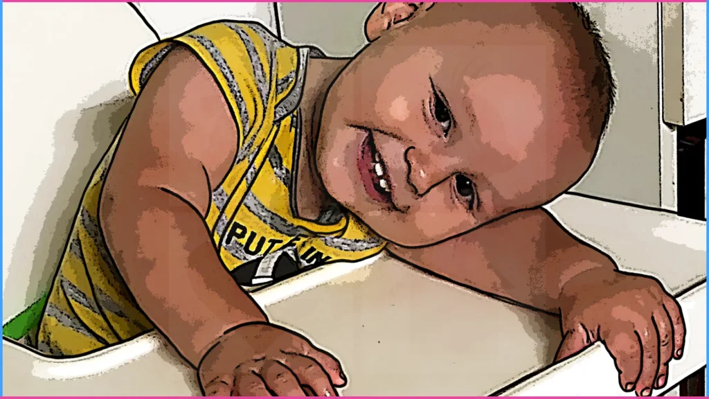 9 hónapos baba etetőszékében kezére hajtja a fejét